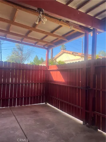 a view of a backyard with wooden fence