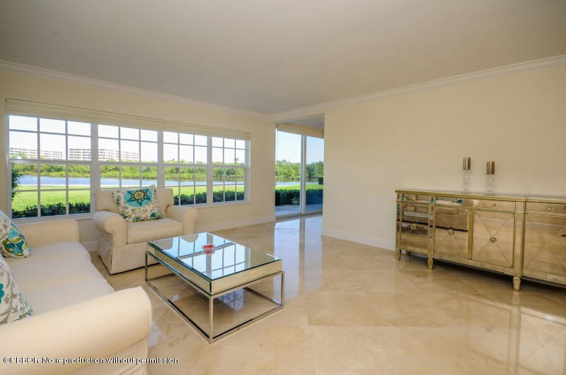 2185 Ibis Isle Road, Unit 2 Palm Beach, FL 33480 - Photo 3 of 26 a living room with furniture and a flat screen tv