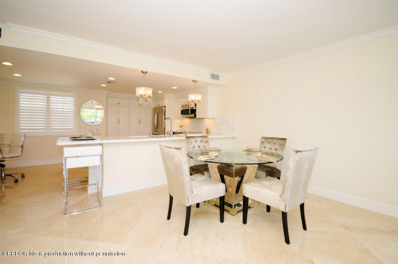 2185 Ibis Isle Road, Unit 2 Palm Beach, FL 33480 - Photo 4 of 26 a dining room with a table and chairs