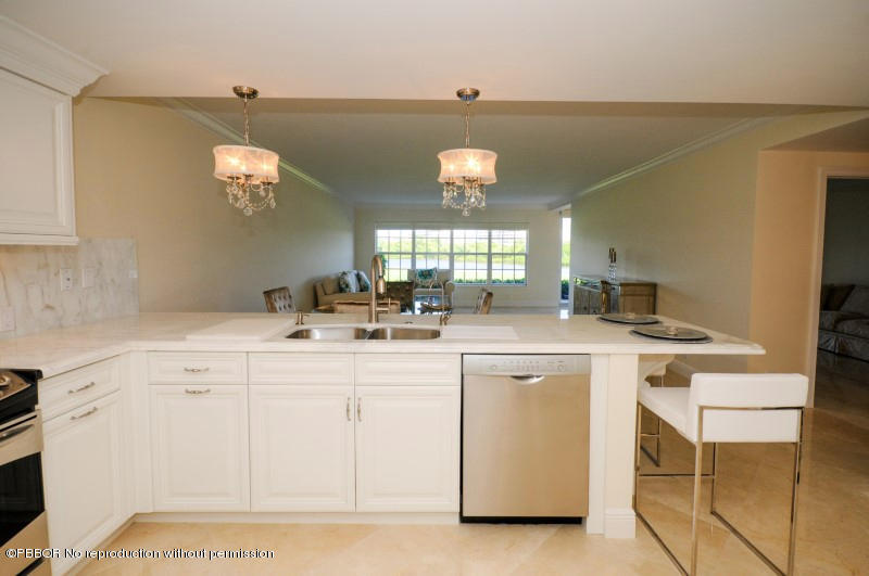 2185 Ibis Isle Road, Unit 2 Palm Beach, FL 33480 - Photo 7 of 26 a kitchen with a sink and a stove top oven