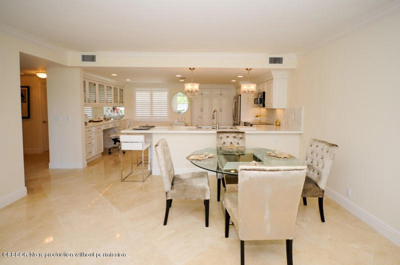2185 Ibis Isle Road, Unit 2 Palm Beach, FL 33480 - Photo 9 of 26 a dining hall with stainless steel appliances kitchen island granite countertop a table and chairs in it