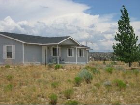 850 West Iris Road, Unit 4 Paulden, AZ 86334 - Photo 1 of 12 a front view of house with yard and trees around