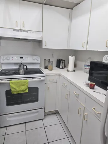 a kitchen with stainless steel appliances granite countertop a sink a stove and cabinets