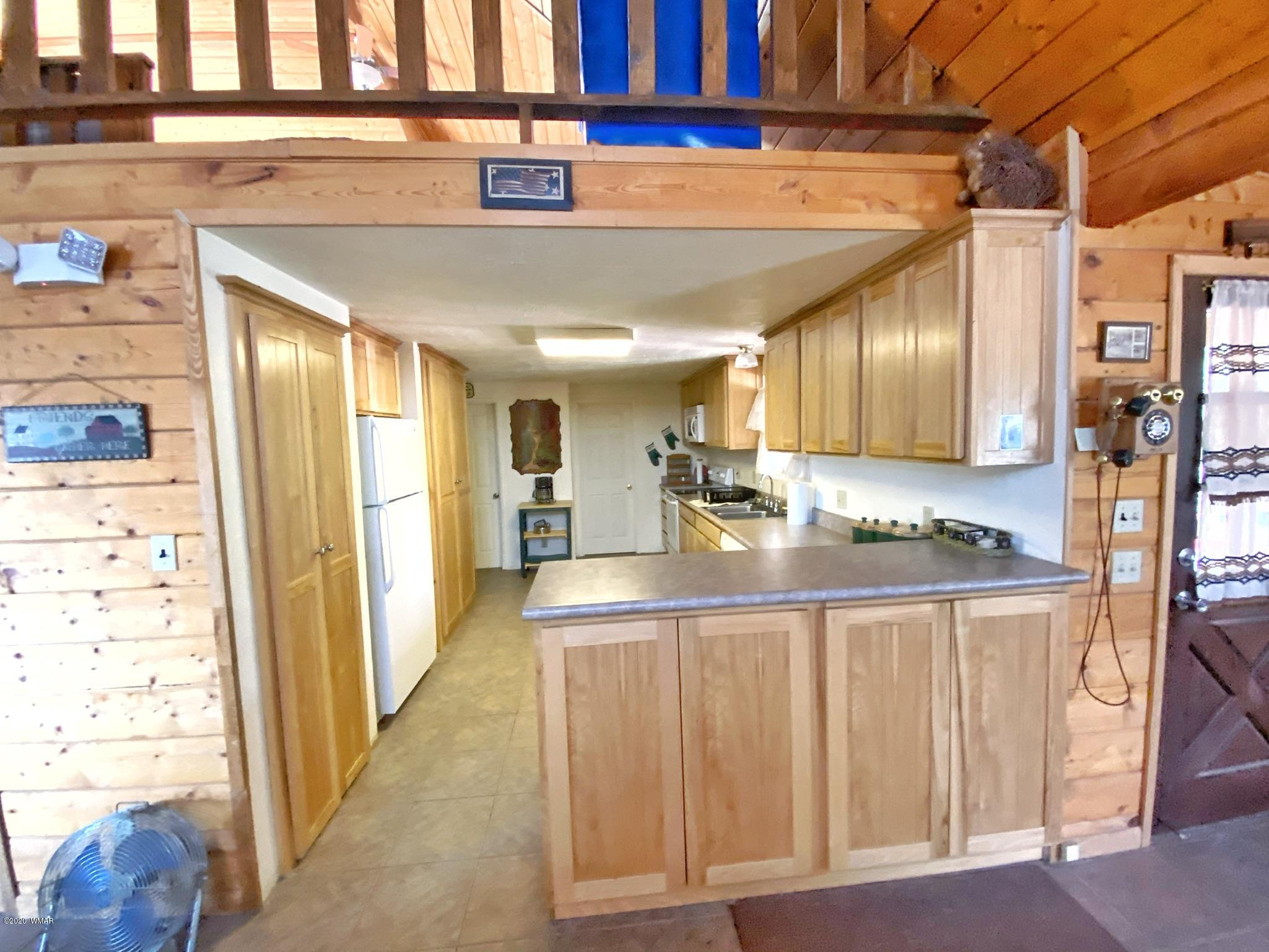 3170 Aspen Road Overgaard, AZ 85933 - Photo 32 of 37 a kitchen with stainless steel appliances granite countertop a refrigerator and a sink