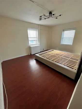 a view of room with hardwood flooring and ceiling fan