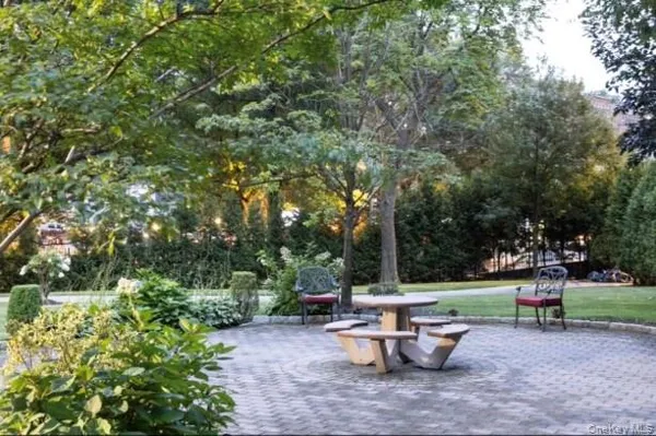 a view of a sitting area with trees in the background