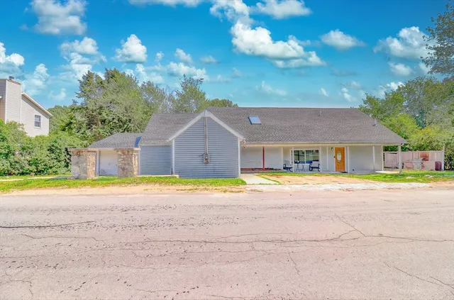 a front view of house with yard and swimming pool