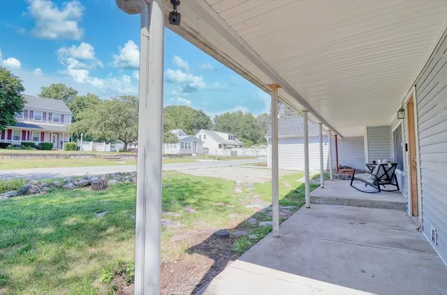 a view of a porch with furniture and garden