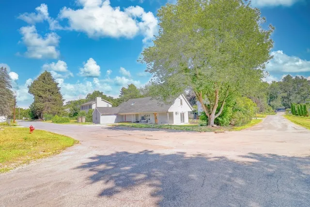 a view of a house with a swimming pool and a yard