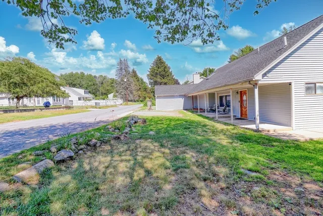 a view of a house with swimming pool and a yard