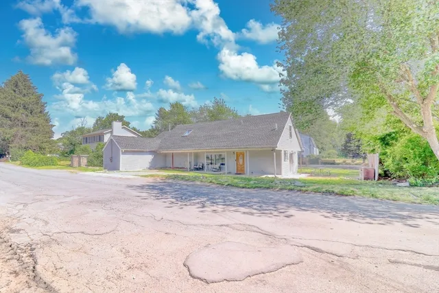 a view of a backyard with large tree