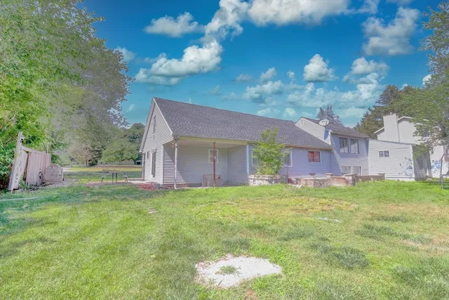 a backyard of a house with table and chairs