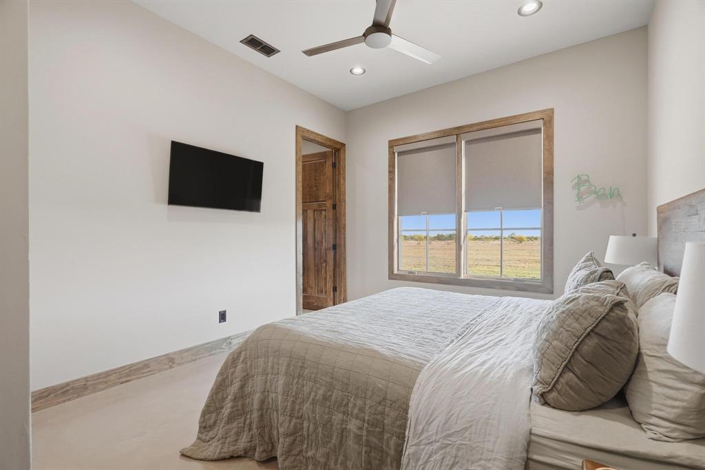 483 County Road 353 Merkel, TX 79536 - Photo 25 of 40 a bedroom with a bed and a flat screen tv