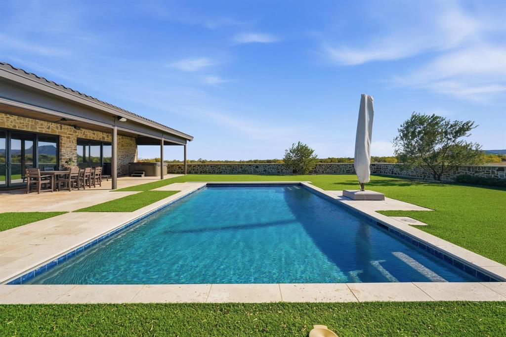 483 County Road 353 Merkel, TX 79536 - Photo 32 of 40 a view of swimming pool with lawn chairs and a yard