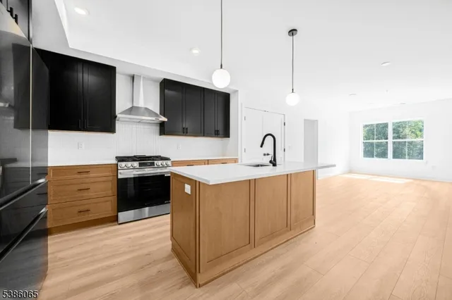 a kitchen with stainless steel appliances a stove sink and microwave