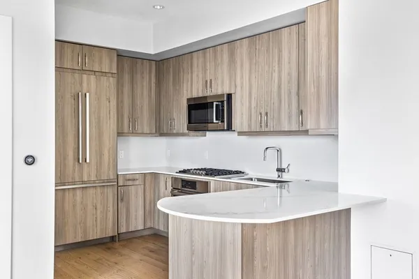 a close view of a sink and a refrigerator in a kitchen