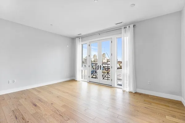 a view of a room with wooden floor