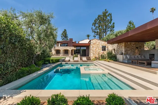 a view of house with swimming pool outdoor seating