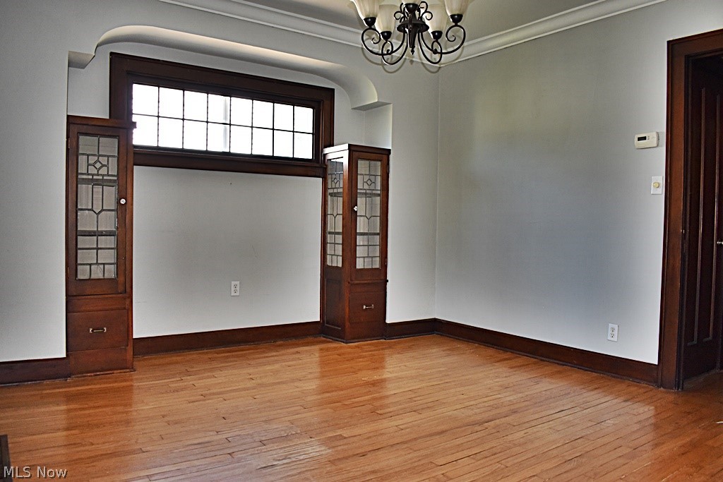 7715 Ackley Road Parma, OH 44129 - Photo 5 of 27 Dining room with ornamental molding, light hardwood flooring, and a chandelier