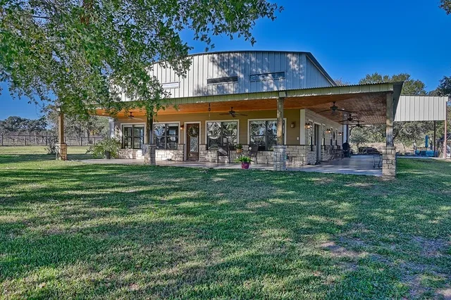 a view of a chairs and tables in the back yard of the house