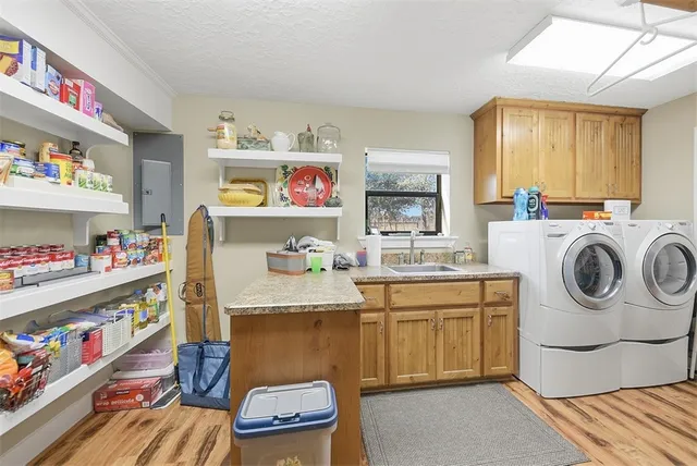 a utility room with cabinets dryer and washer