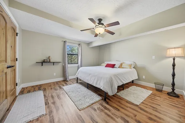 a bedroom with a bed and a ceiling fan