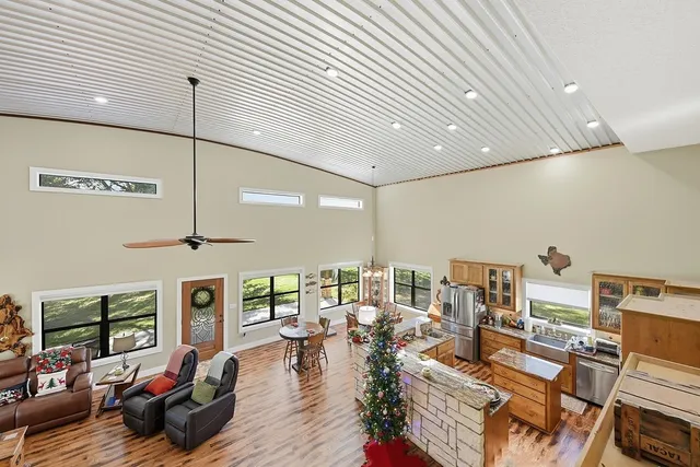 a living room with lots of furniture and a large window