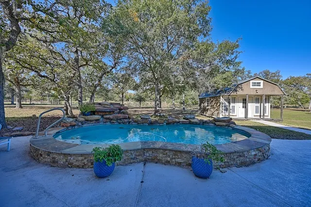 a view of a backyard with sitting area