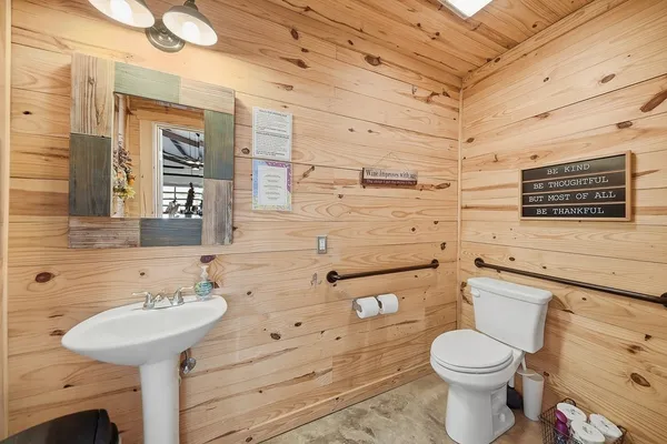 a bathroom with a sink a toilet and shower