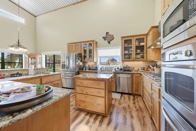 a kitchen with stainless steel appliances granite countertop a stove and a sink