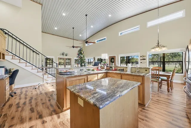 a view of kitchen island with granite countertop lots of counter space