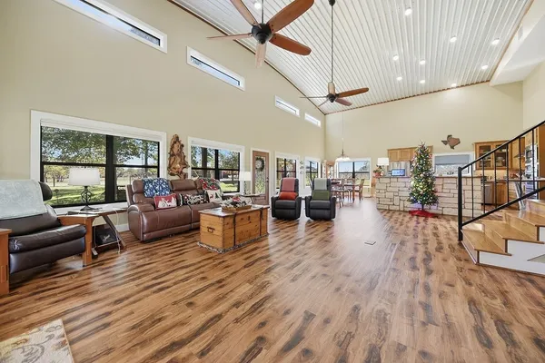 a living room with lots of furniture and a wooden floor