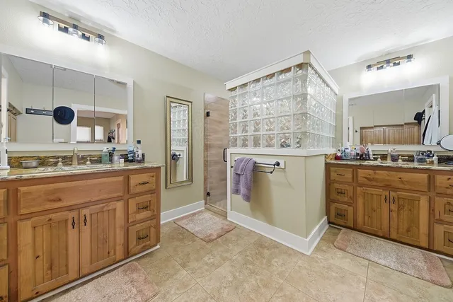 a spacious bathroom with a granite countertop sink mirror and a