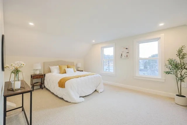 a bedroom with a bed and window