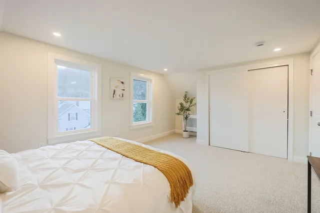 a spacious bedroom with a bed and a window