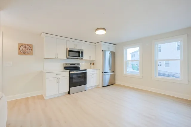 a kitchen with a refrigerator stove and microwave