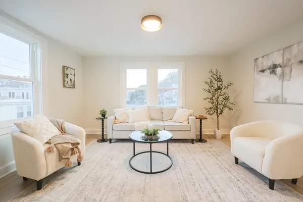 a living room with furniture a window and a table
