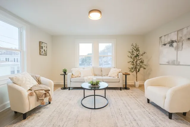 a living room with furniture a window and a table