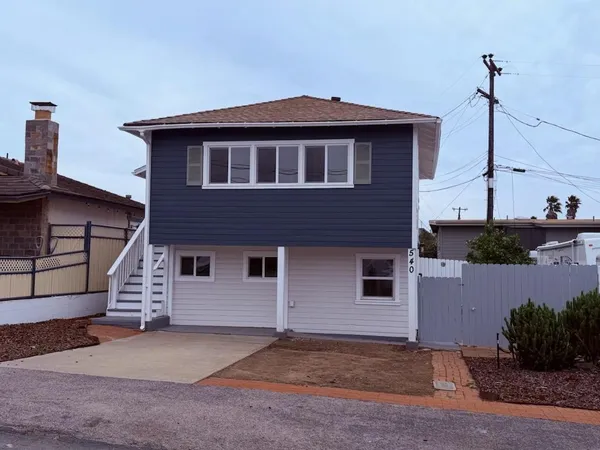 a front view of a house with a garden