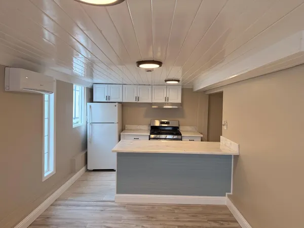 a kitchen with stainless steel appliances a stove refrigerator sink and cabinets
