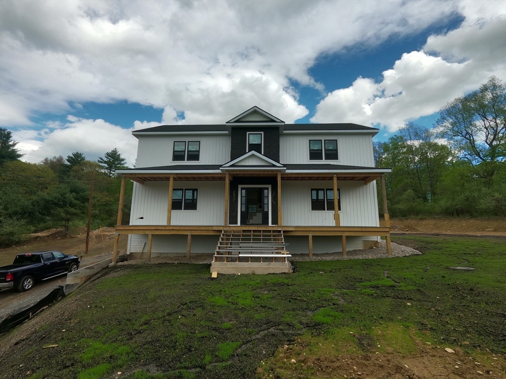 4 Eagleton Street Spencer, MA 01562 - Photo 8 of 11 a front view of a house with a yard