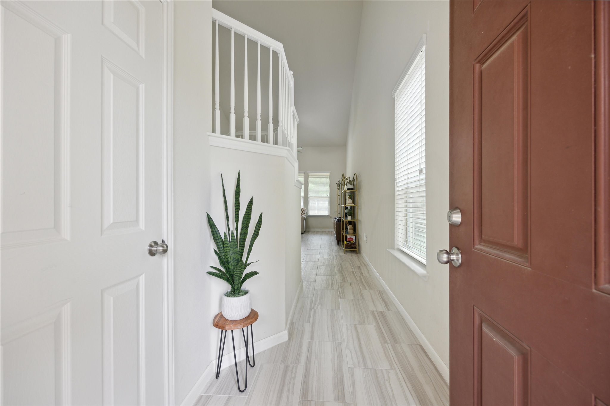 10053 Aly May Drive Austin, TX 78748 - Photo 2 of 15 a view of a hallway with wooden floor and table and chair
