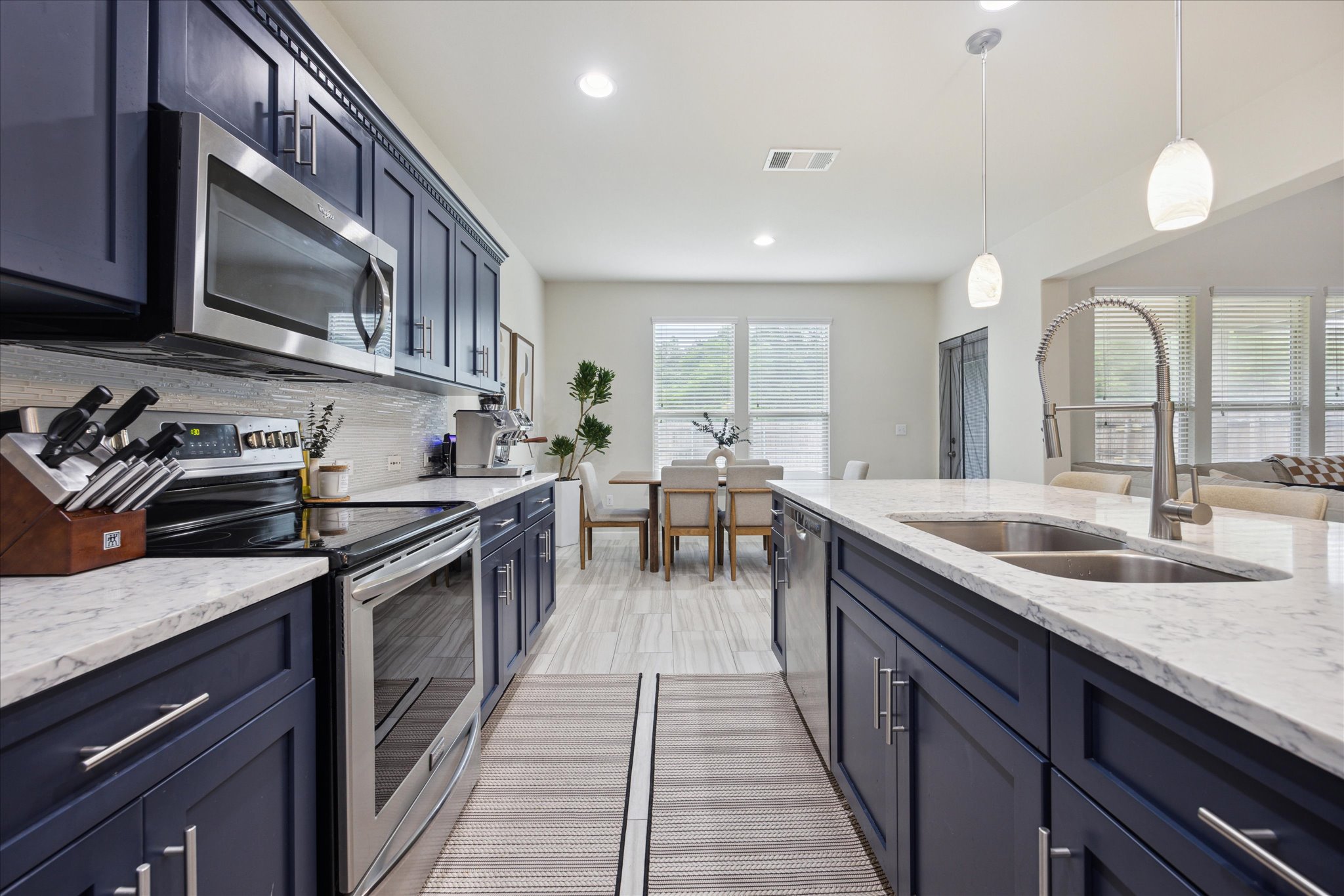 10053 Aly May Drive Austin, TX 78748 - Photo 8 of 15 a kitchen with stainless steel appliances granite countertop a sink stove and cabinets