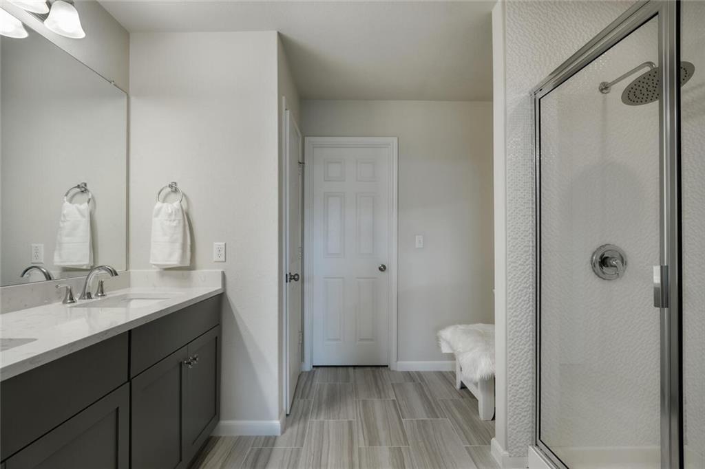 10053 Aly May Drive Austin, TX 78748 - Photo 10 of 15 a bathroom with a sink a toilet and shower