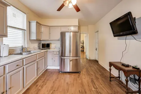 a kitchen with a refrigerator microwave and stove top oven