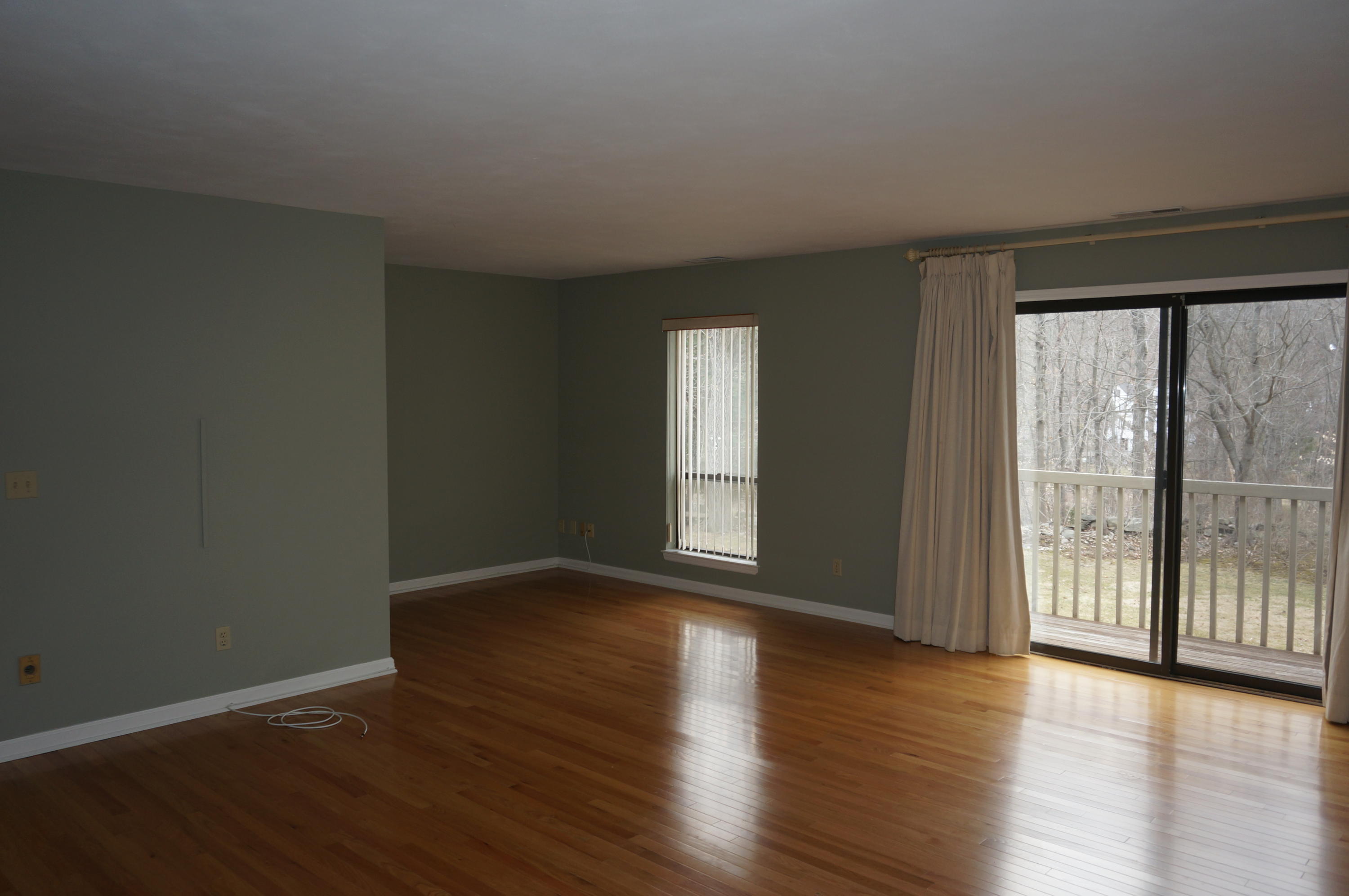 500 River Road, Unit 7 Greenwich, CT 06807 - Photo 14 of 29 a view of an empty room with wooden floor and a window