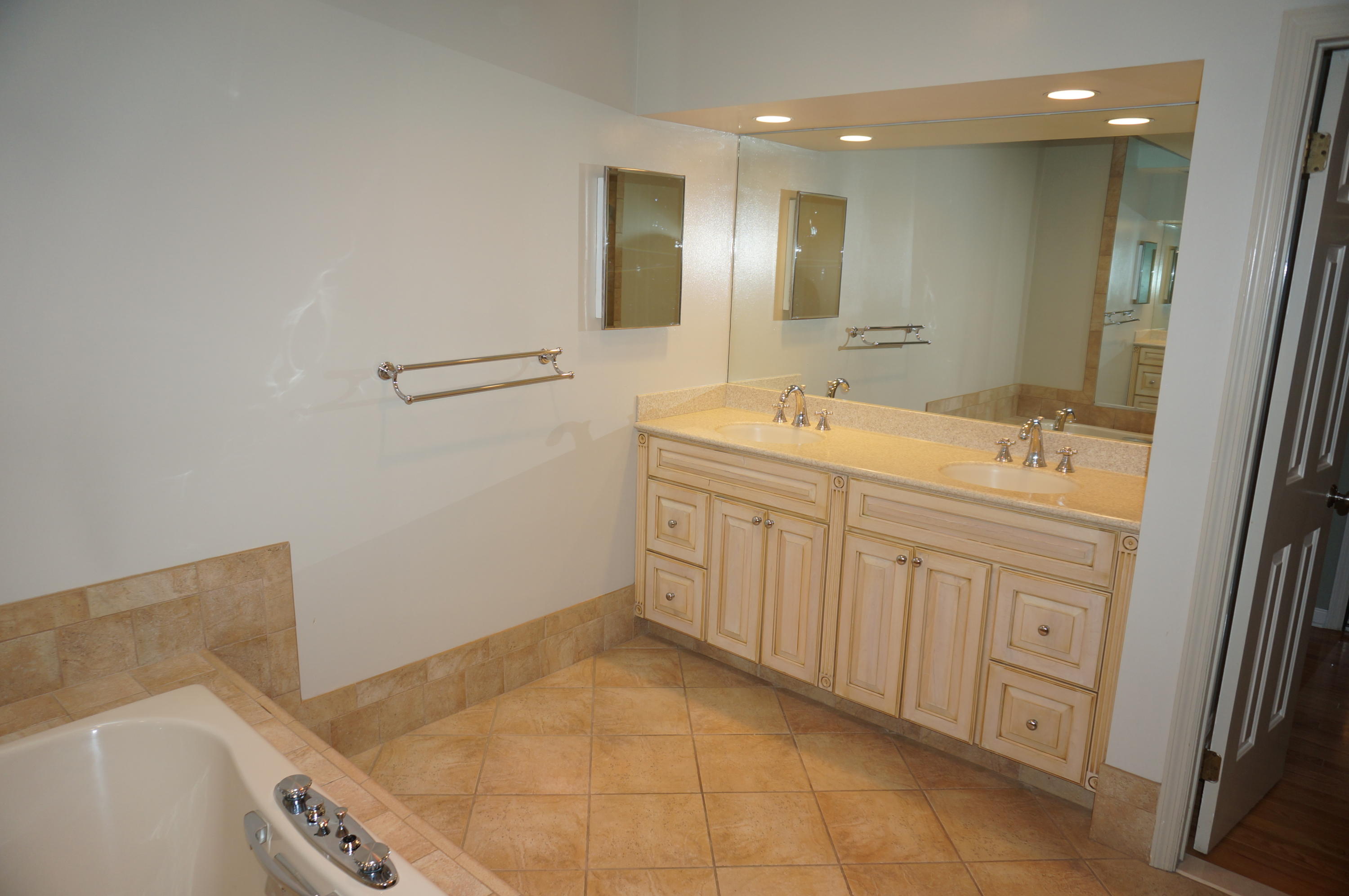 500 River Road, Unit 7 Greenwich, CT 06807 - Photo 17 of 29 a spacious bathroom with a sink a vanity and mirror