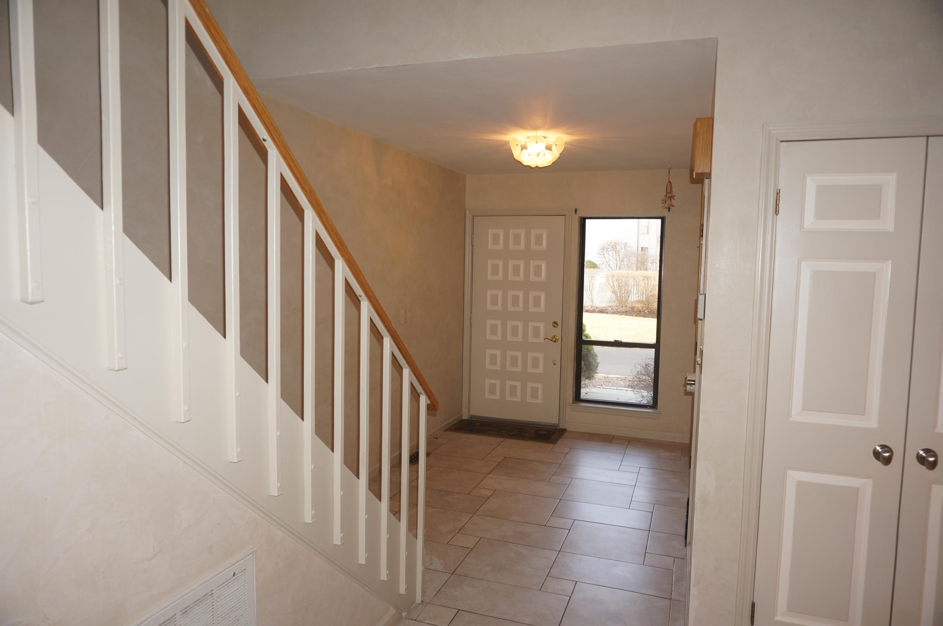 500 River Road, Unit 7 Greenwich, CT 06807 - Photo 3 of 29 a view of a hallway with entryway and stairs