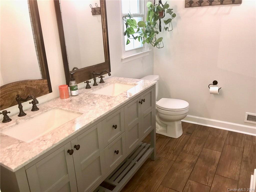 708 Trail Ridge Road Matthews, NC 28105 - Photo 14 of 40 a bathroom with a granite countertop sink and a mirror
