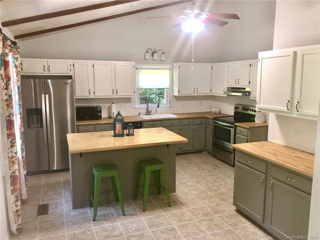 708 Trail Ridge Road Matthews, NC 28105 - Photo 19 of 40 a kitchen with granite countertop a sink stainless steel appliances and cabinets